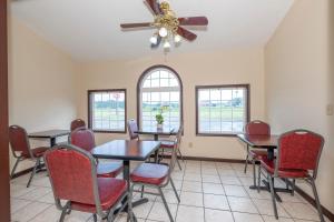 a dining room with tables and chairs and windows at Red Roof Inn Abingdon in Abingdon