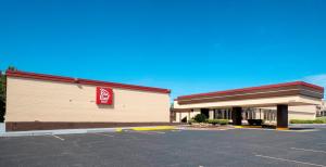 a store with a sign on the side of a parking lot at Red Roof Inn Murray in Murray