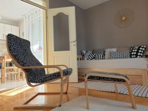 a bedroom with a chair and a bed and a table at Stan na dan "Irina" Banja Luka in Banja Luka +8 photos