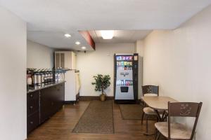 a dining room with a table and a refrigerator at Red Roof Inn Grand Rapids Airport in Cascade