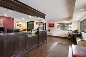a large lobby with a bar in a restaurant at Red Roof Inn Grand Rapids Airport in Cascade