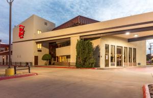 a large building with a red sign on it at Red Roof Inn Wichita Falls in Wichita Falls