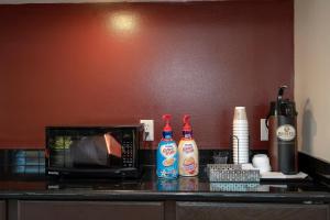 a counter with a microwave and bottles of sauce at Red Roof Inn PLUS+ St. Augustine in St. Augustine