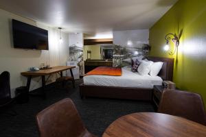 a hotel room with a bed and a table with chairs at Campfire Hotel in Bend