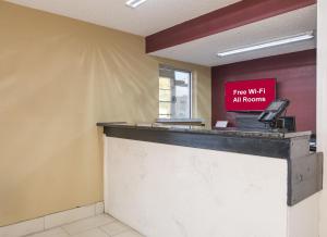 a cash counter with a sign that reads fire wait all rooms at Red Roof Inn Acworth - Emerson - LakePoint South in Acworth