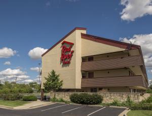 a building with a sign on the side of it at Red Roof Inn Cincinnati - Sharonville in Sharonville