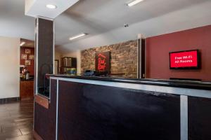 a bar in a restaurant with a sign on the wall at Red Roof Inn Neptune - Jersey Shore in Neptune City