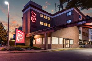 a building with neon signs on the side of it at Red Roof Inn Seattle Airport - SEATAC in SeaTac