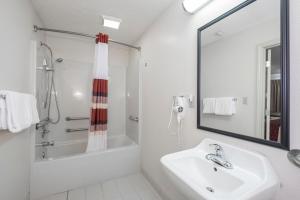 a white bathroom with a sink and a shower at Red Roof Inn Columbus Northeast Westerville in Westerville +16 photos