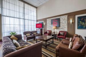a waiting room with couches and a table and a tv at Red Roof Inn Meridian in Meridian