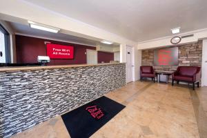 a lobby with a bar with a sign that reads hear with all hazards at Red Roof Inn Crestview in Crestview