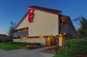 a restaurant with a sign on the side of a building at Red Roof Inn Detroit - Warren in Warren