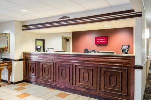 a hotel lobby with a large wooden reception desk at Red Roof Inn Hendersonville in Hendersonville