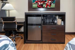 a room with a desk with a microwave and a refrigerator at Red Roof Inn Freehold in Freehold