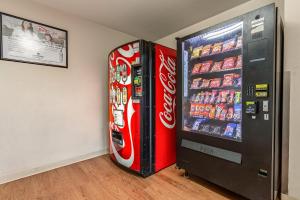a coca cola refrigerator and a soda vending machine at Studio 51 Extended Stay Hotel in Phoenix