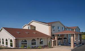 a large house with a brown roof at Red Roof Inn Osage Beach - Lake of the Ozarks in Osage Beach