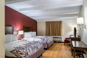 a hotel room with two beds and a desk at Red Roof Inn Richmond, IN in Richmond +26 photos