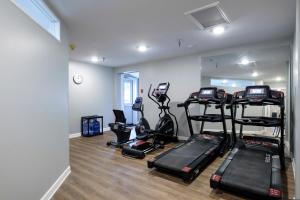 a gym with treadmills and ellipticals in a room at Red Roof Inn and Suites Herkimer in Herkimer