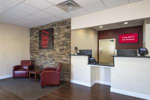 a waiting room with a table and chairs at Red Roof Inn Clearfield in Clearfield