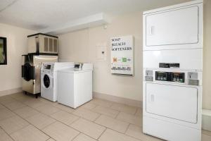 a laundry room with white appliances on the wall at Red Roof Inn Gadsden in Gadsden