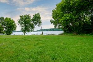 a field of grass with a lake in the background at Red Roof Inn Gadsden in Gadsden