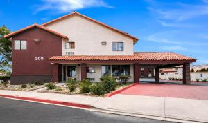 a large red building with a red roof at Red Roof Inn Palmdale - Lancaster in Palmdale