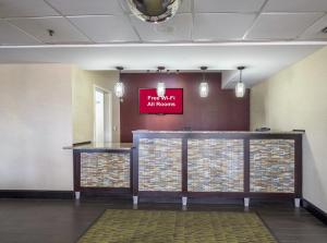 a lobby with a sign that reads firemit all rooms at Red Roof Inn Ames in Ames