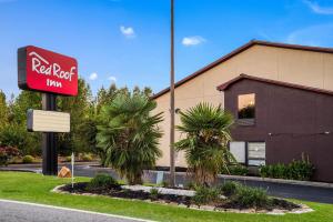 a red motel sign in front of a building at Red Roof Inn Spartanburg - I-26 in Spartanburg