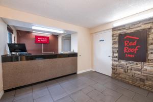 a lobby with a red rock war sign on a wall at Red Roof Inn Mobile - Midtown in Mobile