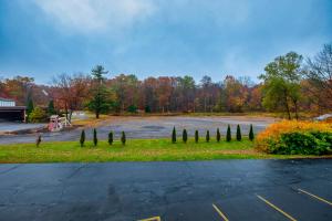 a parking lot with a bunch of trees in a park at Red Roof Inn & Suites Hazleton in Hazleton