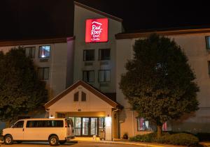 a white van parked in front of a hotel at Red Roof Inn & Suites Indianapolis Airport in Indianapolis