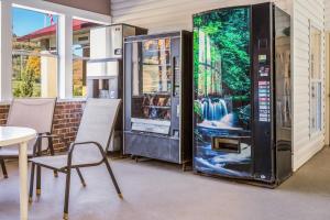 a large black vending machine next to a table and chairs at Red Roof Inn Chattanooga - Lookout Mountain in Chattanooga