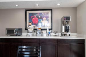 a kitchen with a counter top with a microwave and coffee maker at Red Roof Inn Houston North - FM1960 & I-45 in Houston