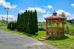a wooden gazebo in a park next to trees at Red Roof Inn Hillsville in Hillsville