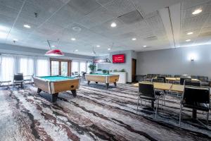 a room with ping pong tables and chairs in it at Red Roof Inn Fulton in Fulton