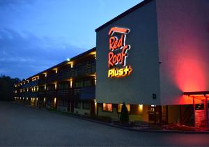 a building with a red rock trust sign on it at Red Roof Inn PLUS+ Pittsburgh East - Monroeville in Monroeville