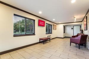 a waiting room at a hospital with a chair and a window at Red Roof Inn Dry Ridge in Dry Ridge