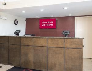 a sign that says free wifi all rooms on a wall at Red Roof Inn Bloomington - Normal/University in Bloomington