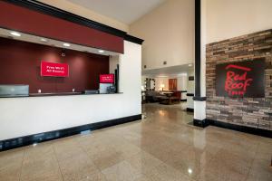 a restaurant lobby with a red roof inn sign on the wall at Red Roof Inn Charlotte - University in Charlotte