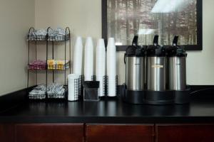 a counter top with two silver and black thermos at Red Roof Inn Charlotte - University in Charlotte
