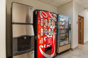 a coca cola refrigerator next to a soda machine at Red Roof Inn Panama City in Panama City