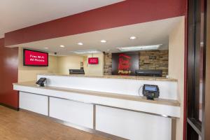 a lobby of a hospital with a reception counter at Red Roof Inn PLUS+ & Suites Naples Downtown-5th Ave S in Naples
