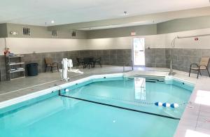 a large swimming pool with blue water at Red Roof Inn & Suites Omaha - Council Bluffs in Council Bluffs