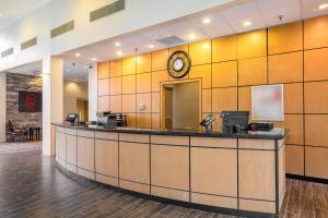 a hotel lobby with a clock on the wall at Red Roof Inn & Suites Mt Holly - McGuire AFB in Westampton Township