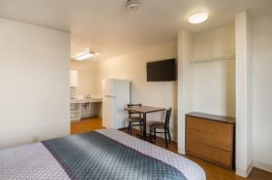 A bed or beds in a room at HomeTowne Studios by Red Roof Denver - Airport/Aurora