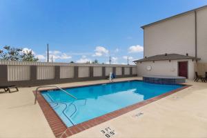 a swimming pool on top of a building at Red Roof Inn PLUS + Galveston - Beachfront in Galveston