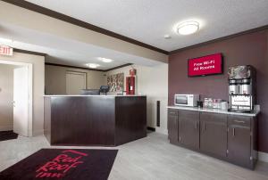 a restaurant with a bar and a kitchen with a counter at Red Roof Inn Dayton Huber Heights in Dayton