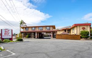 a building with a parking lot in front of it at Red Roof Inn & Suites Monterey in Monterey