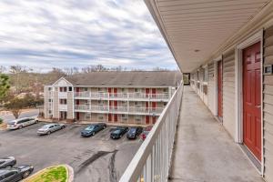 a balcony of a hotel with cars parked in a parking lot at HomeTowne Studios by Red Roof Gainesville, GA in Gainesville