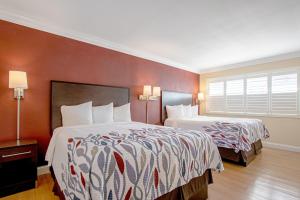 A bed or beds in a room at Red Roof Inn & Suites Monterey